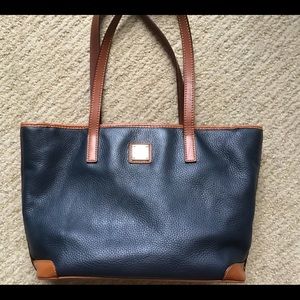 Classic Dooney Bourke in navy leather, brown trim.